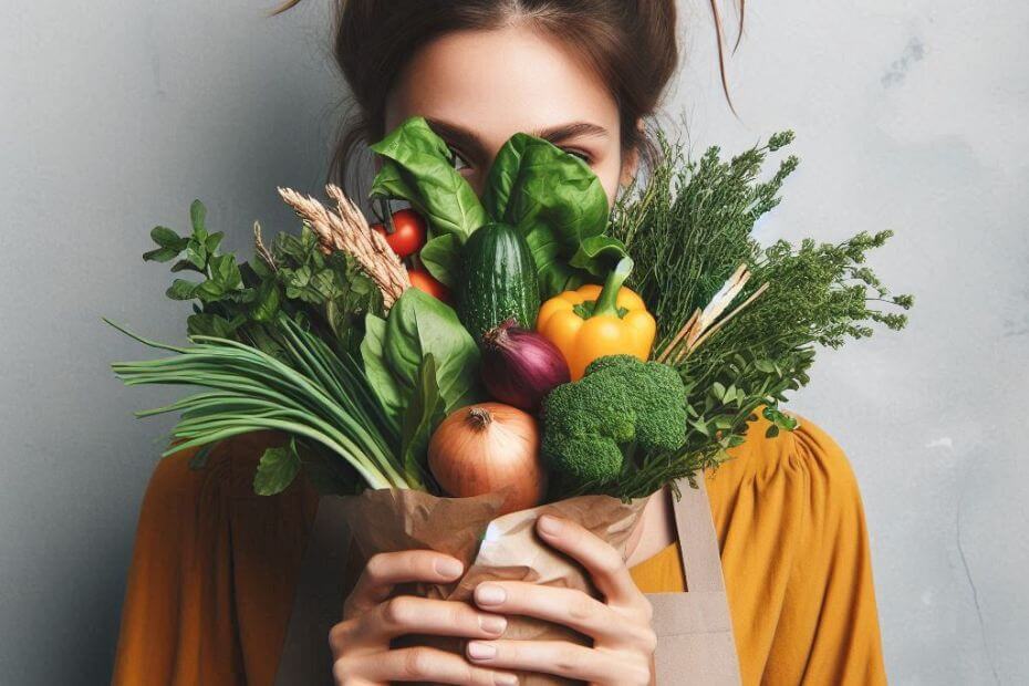 about my story behind my food blog featuring a female holding fresh veggies close to hide her face