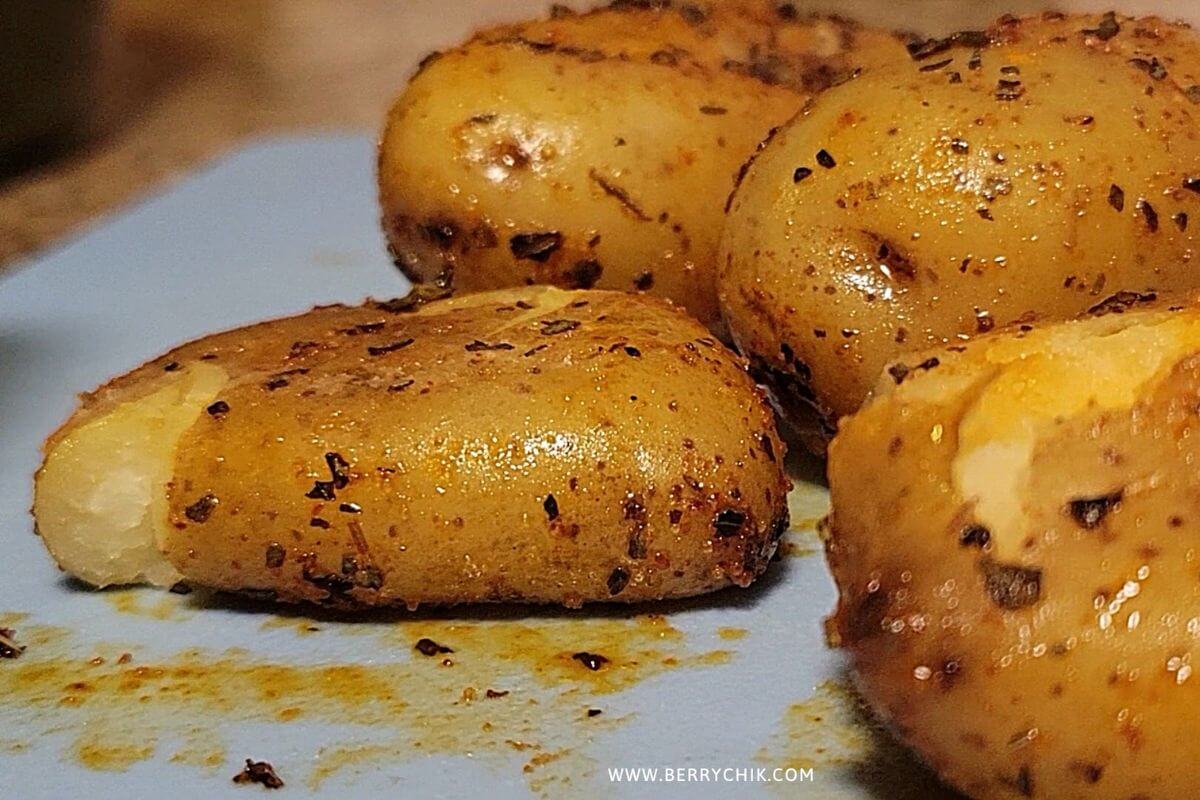 Close‑up of crunchy smashed air-fried potatoes showing crispy ridges and soft centers.  