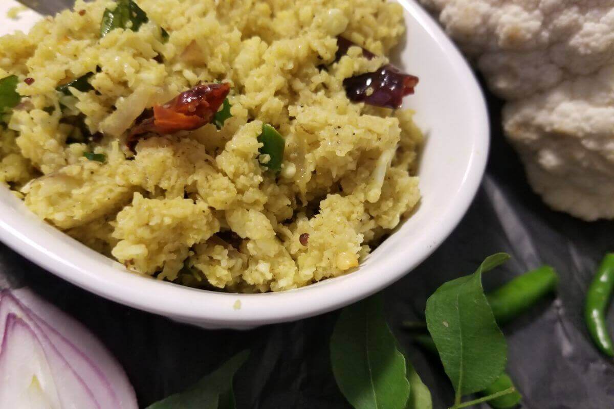 Cauliflower coconut stir‑fry served on a plate with toasted spices and coconut. 