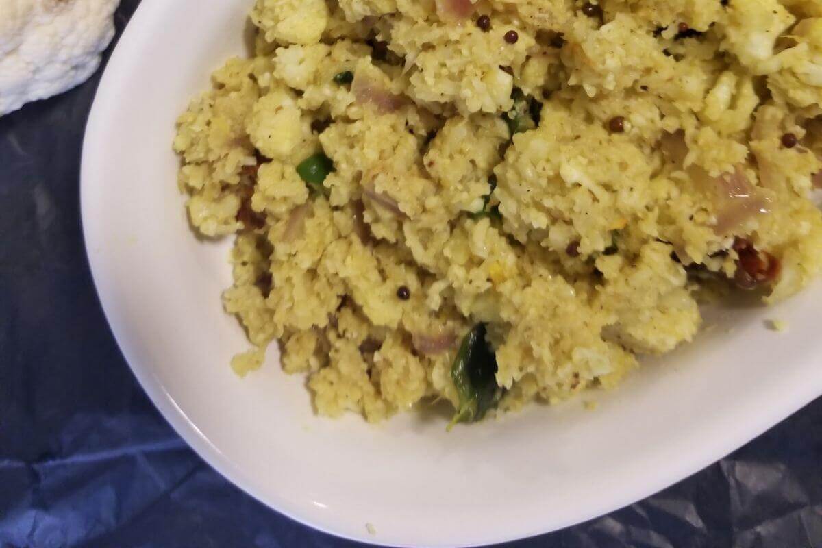 Overhead view of cauliflower coconut stir‑fry on a serving plate. 
