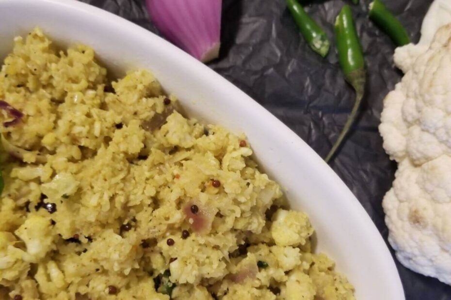 Close‑up of cauliflower stir‑fry showing toasted coconut and spices.