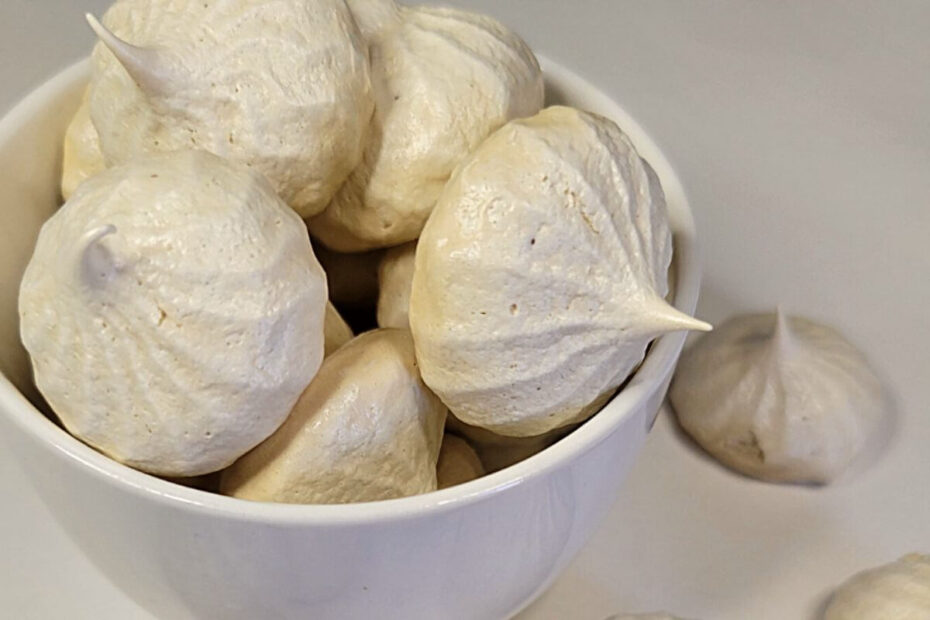 Coffee meringues piped into swirls, crisp and golden with a glossy finish.
