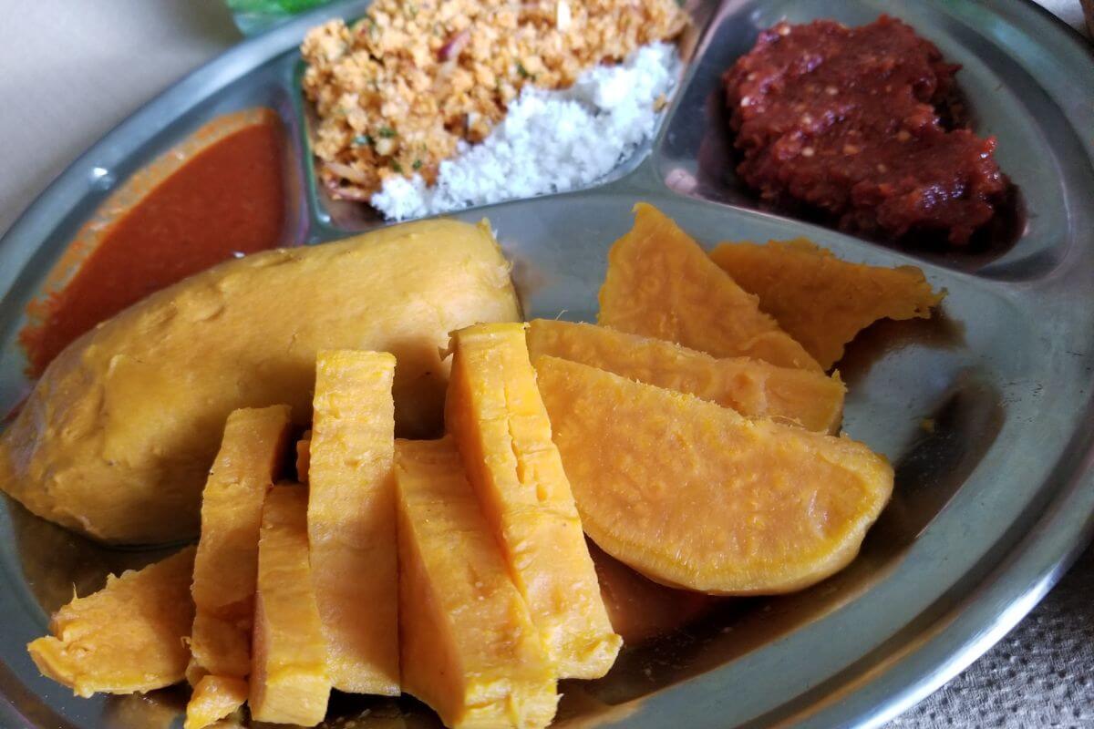 Boiled sweet potatoes served with coconut sambal on the side.