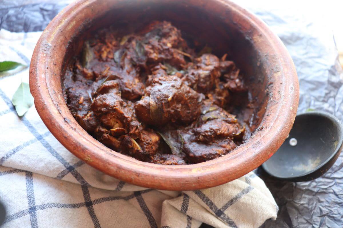 Ambul Thiyal cooked in a clay pot with curry leaves, pandan, and spices.
