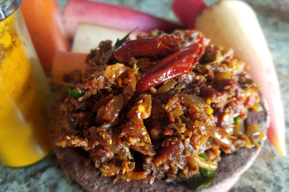 Close-up of banana blossom stir-fry with onions, tomatoes, and Sri Lankan spices.