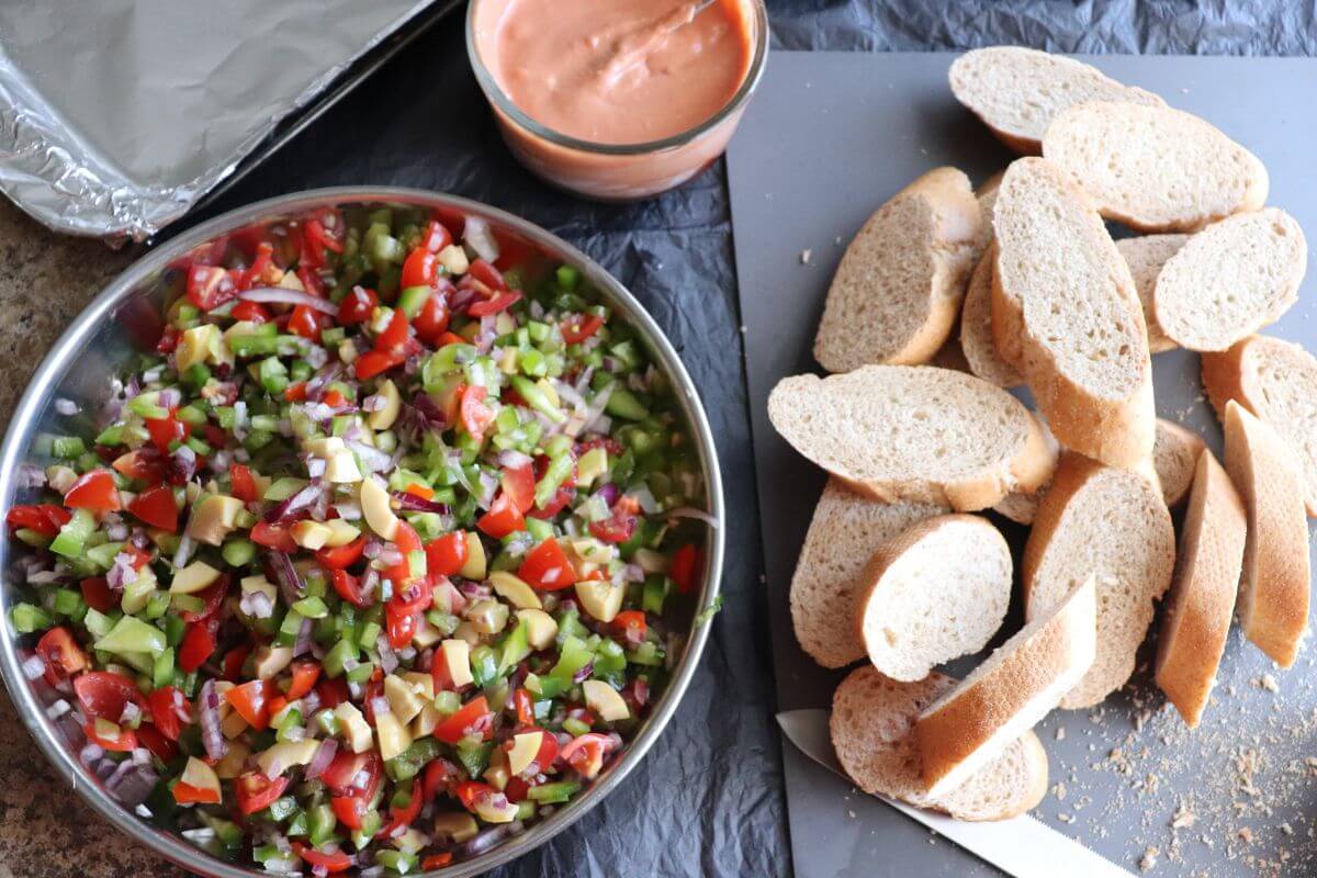 Chopped vegetables and spread ready for bruschetta assembly