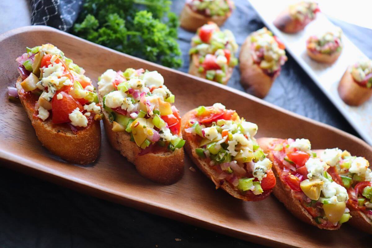 image featuring Garlic-infused toasted baguette topped with colorful diced vegetables and melted cheese