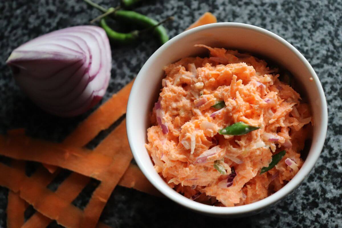 Carrot sambal in a bowl with grated carrots, yogurt, and chilies.