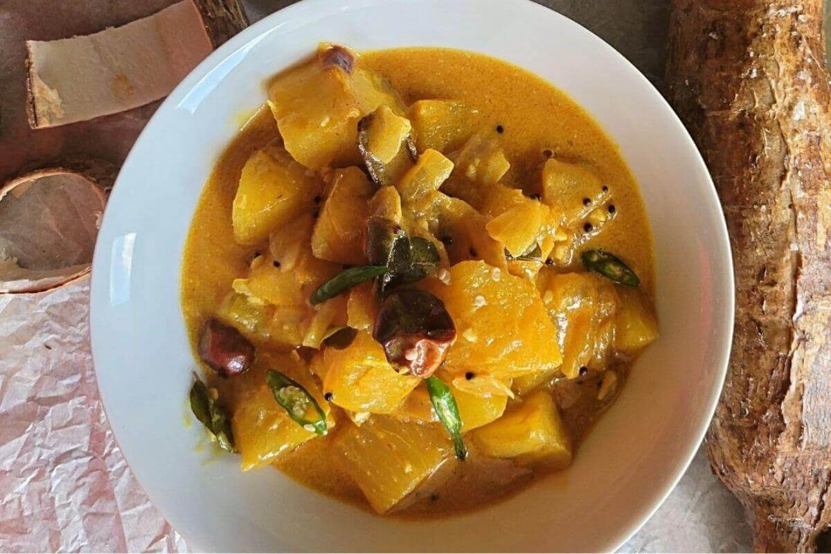 Cassava curry served on a plate with creamy coconut sauce and bold spices.