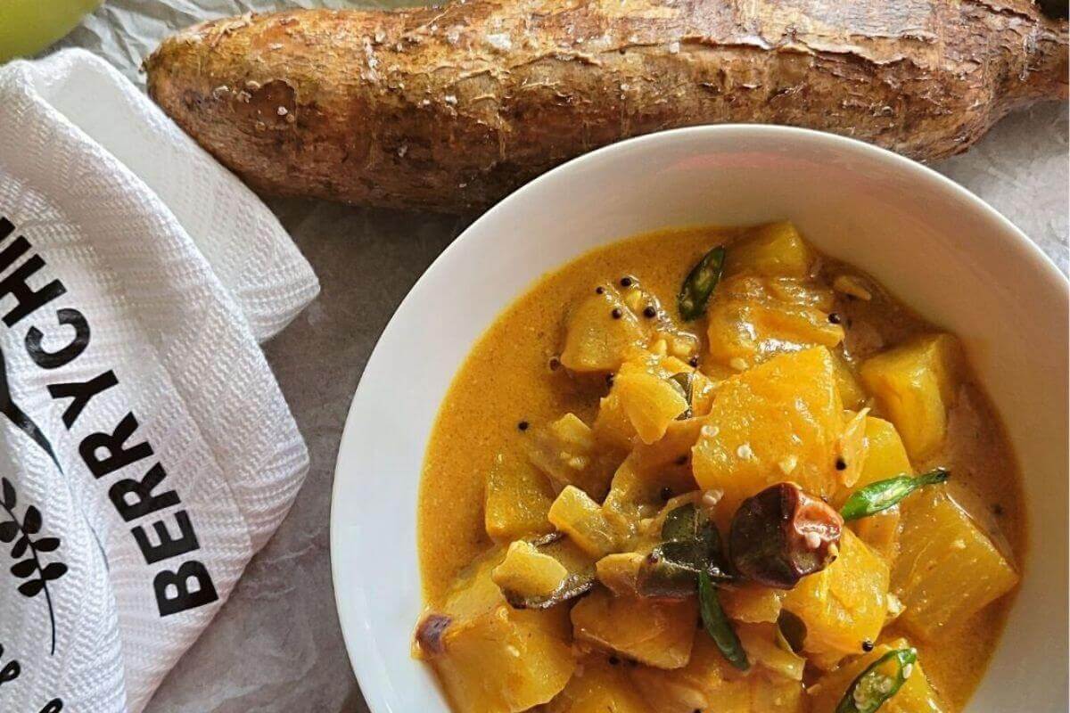 Overhead view of cassava curry with coconut milk and chili garnish.