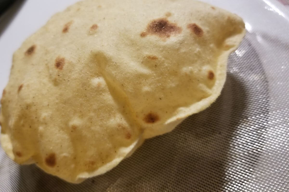 Close‑up of a freshly cooked chapati showing its soft, layered texture.