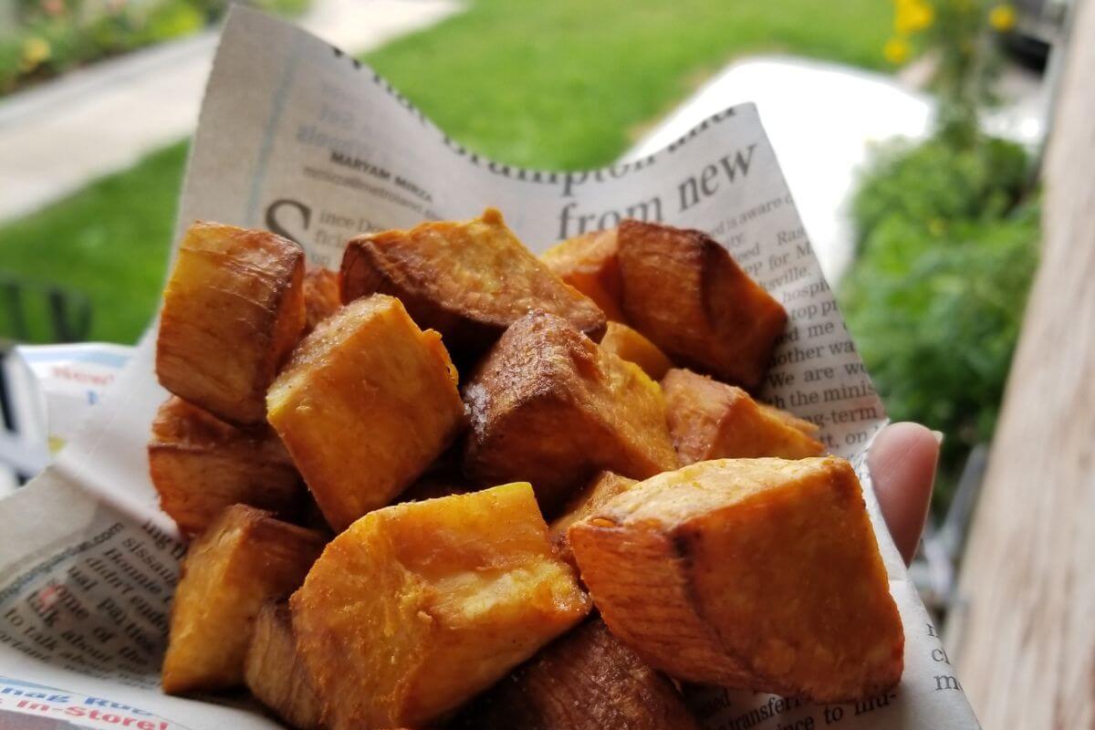 Overhead shot of deep‑fried cassava on a papper