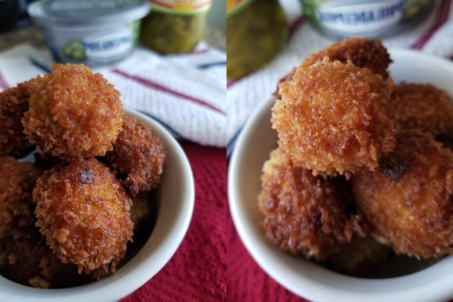 Freshly baked jalapeño poppers in a bowl, topped with melted cheese and crispy crumbs.