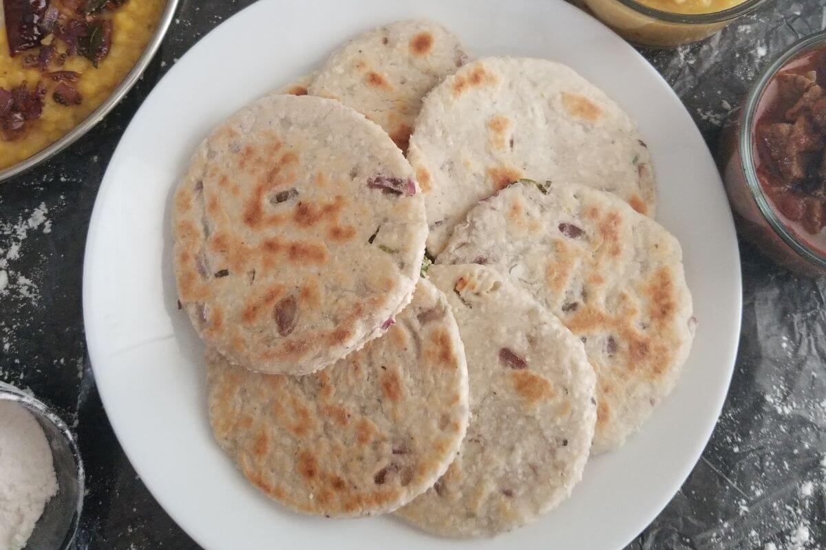 circle of Sri Lankan coconut roti served warm on a plate.