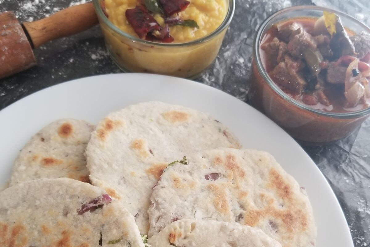 Overhead view of coconut roti arranged on a serving plate.