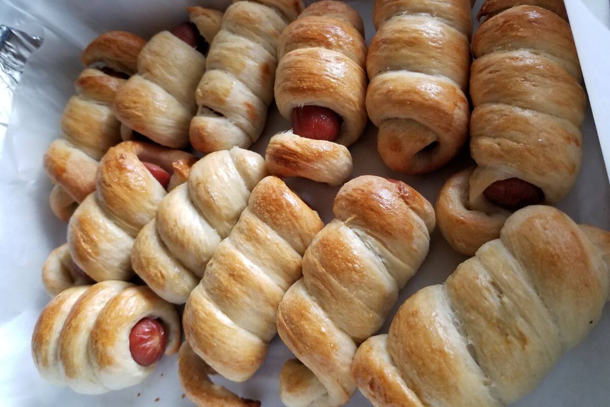 Overhead view of homemade hotdog buns displayed as a party snack.