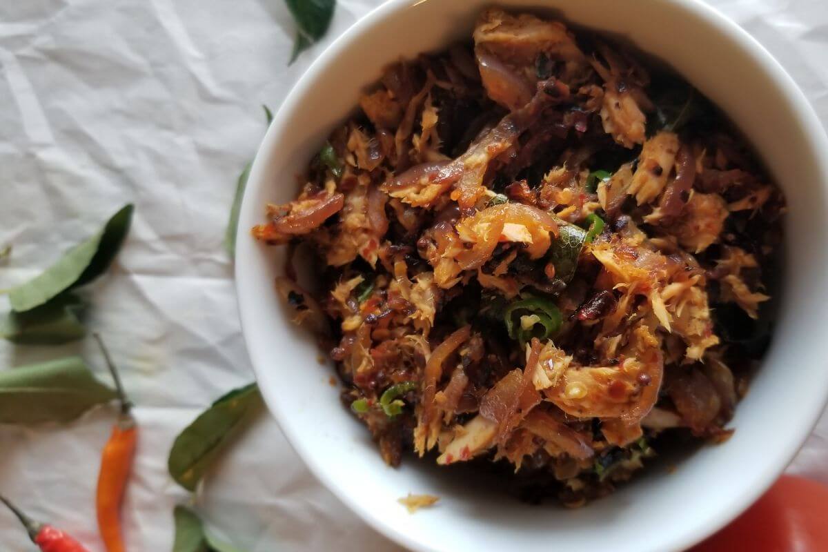 wide view of the tuna fish sambal with ingredients scattered on the side
