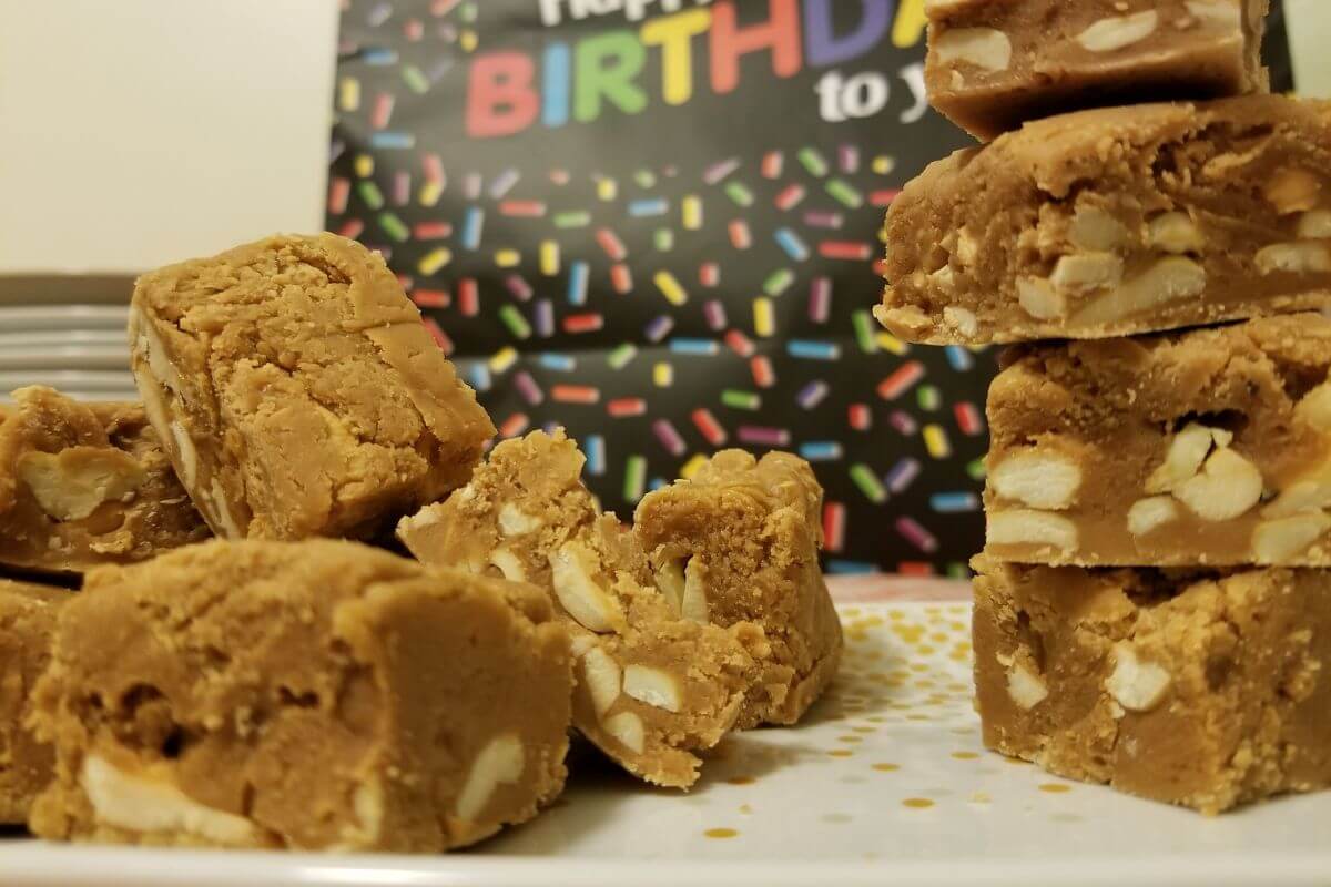 milk toffee stacked on one side while scattered a bunch on another side served at a birthday party