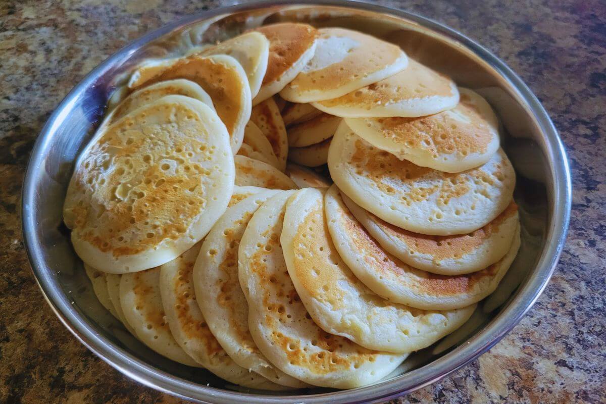 handful of pancakes placed in a circle plated to enjoy