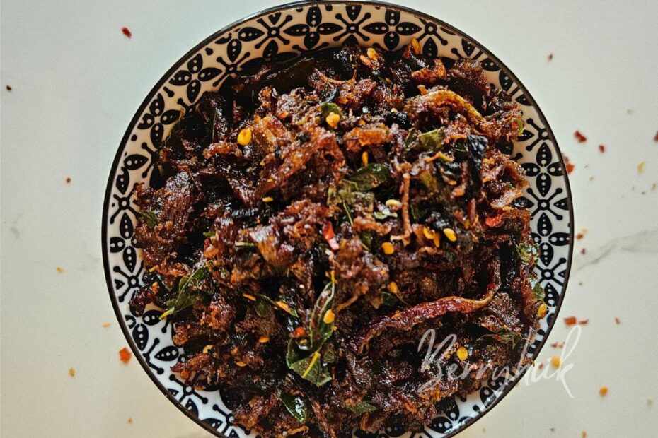 sri-lankan muslim-style pulled beef fry plated in a bowl ready to be paired with a biryani meal
