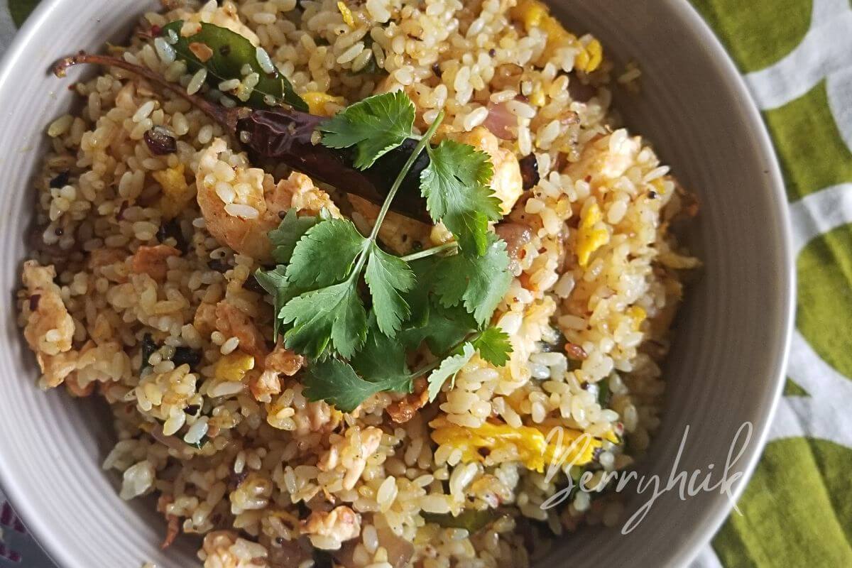 sri lankan egg rice tempered to flavour, platted, and garnished