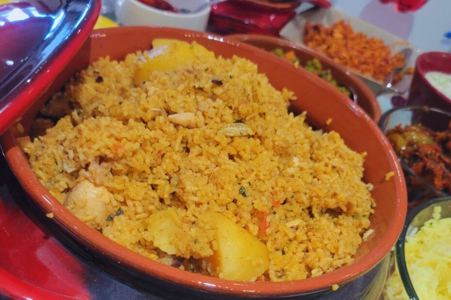 Close‑up of fluffy Instant Pot biriyani in a pot with tender meat, potatoes, and aromatic rice