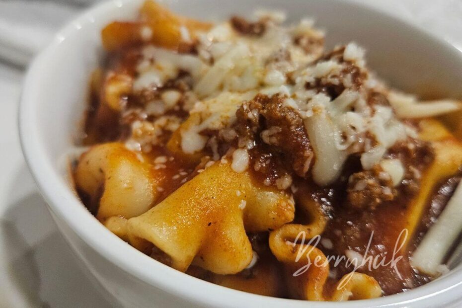 lasagna in a bowl with cheese on top ready to eat