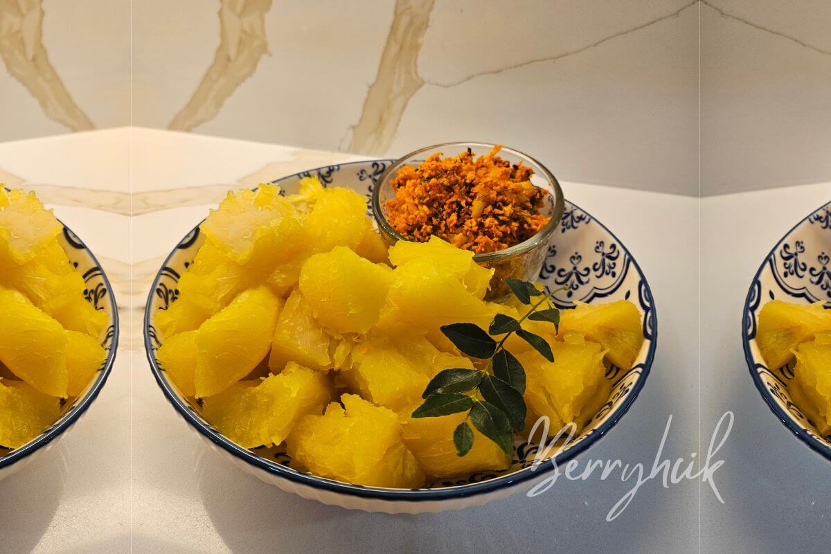 Boiled cassava and coconut sambal served in a bowl on a kitchen counter.