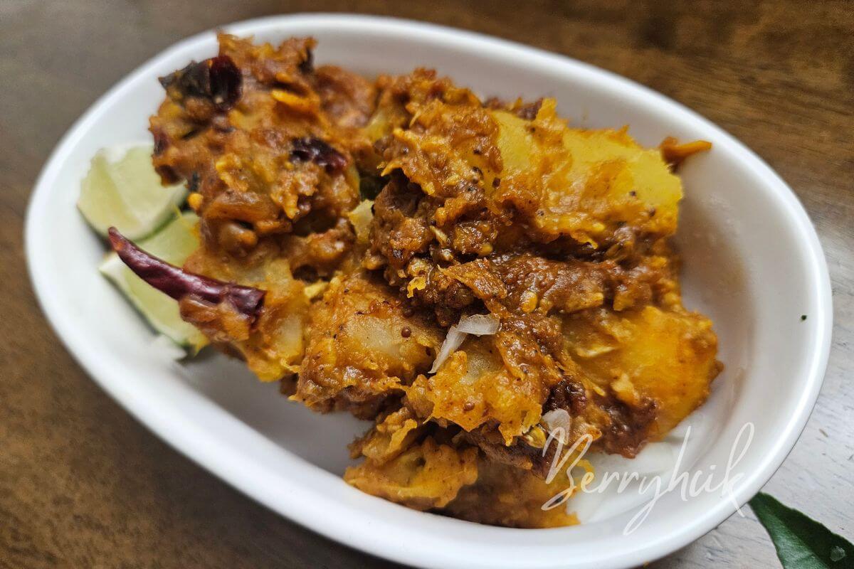 Top view of Kappa Fish with golden tapioca and red Kerala-style fish masala.