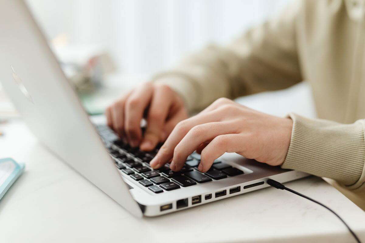 Laptop showing WordPress pages screen as someone builds essential blog pages