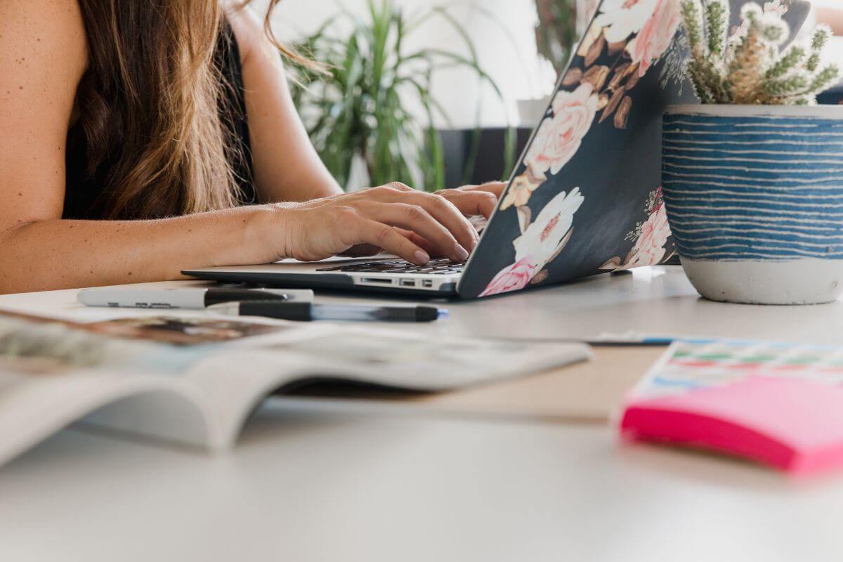 Person working from home creating About and Contact pages on WordPress