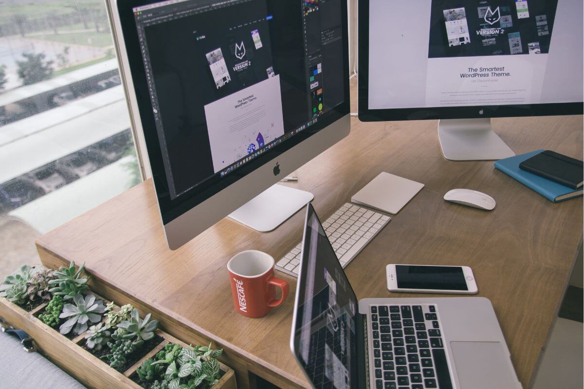 Laptop on a home desk showing essential WordPress plugins for food bloggers