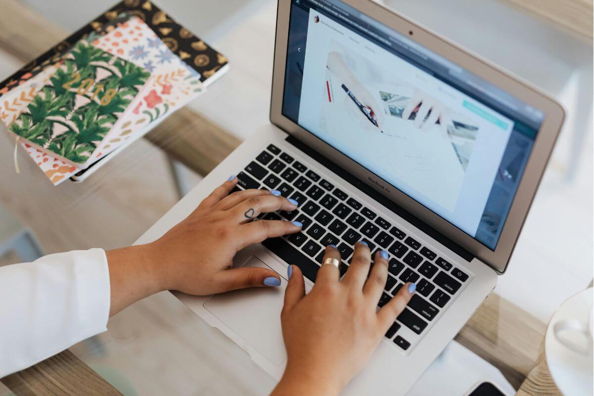 Food blogger working from home on a laptop, writing their first blog post for WordPress