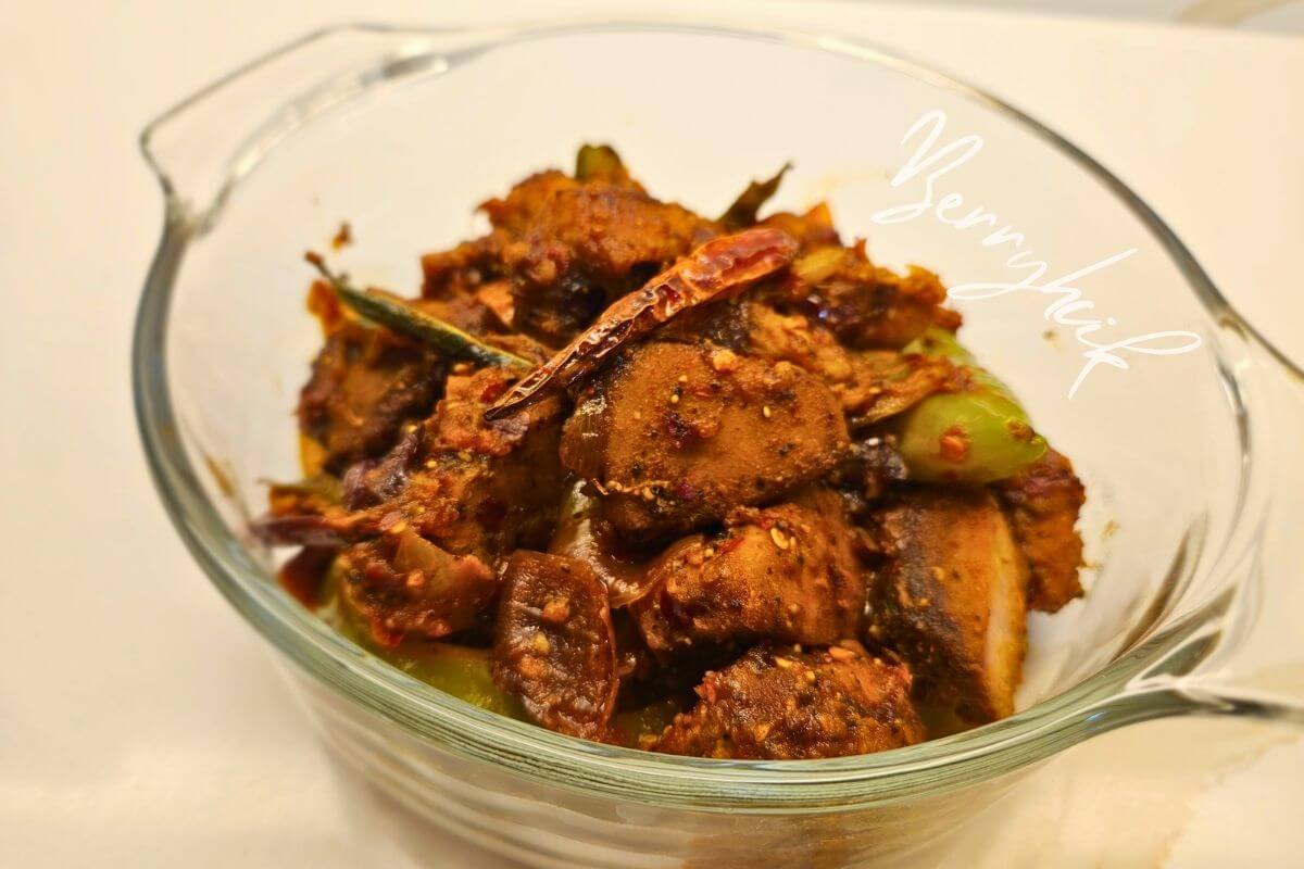 Sri Lankan deviled fish coated in a glossy sweet‑spicy sauce with onions, peppers, and curry leaves.
