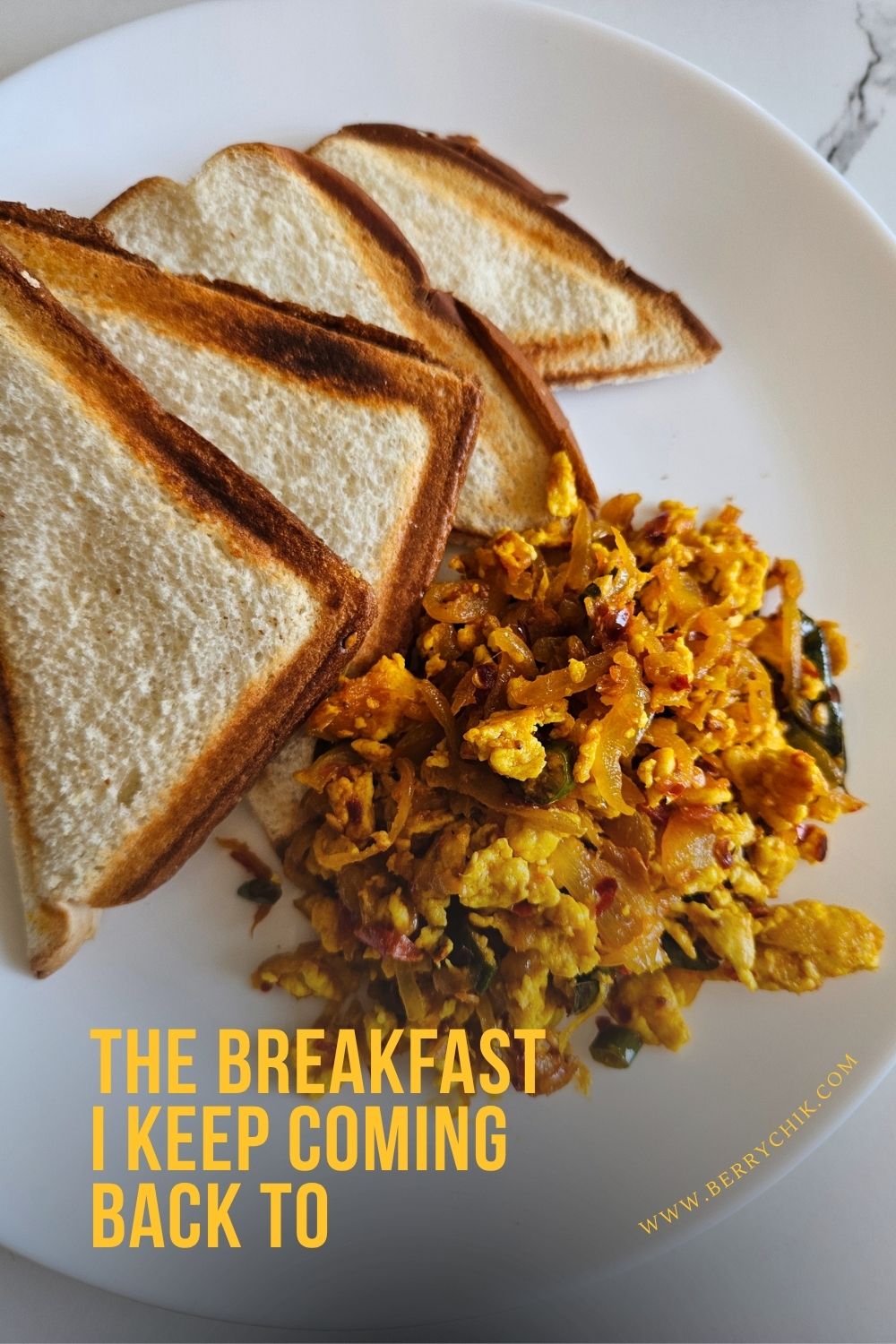 Sri Lankan scrambled egg sambal served with four slices of toasted bread on a white plate.