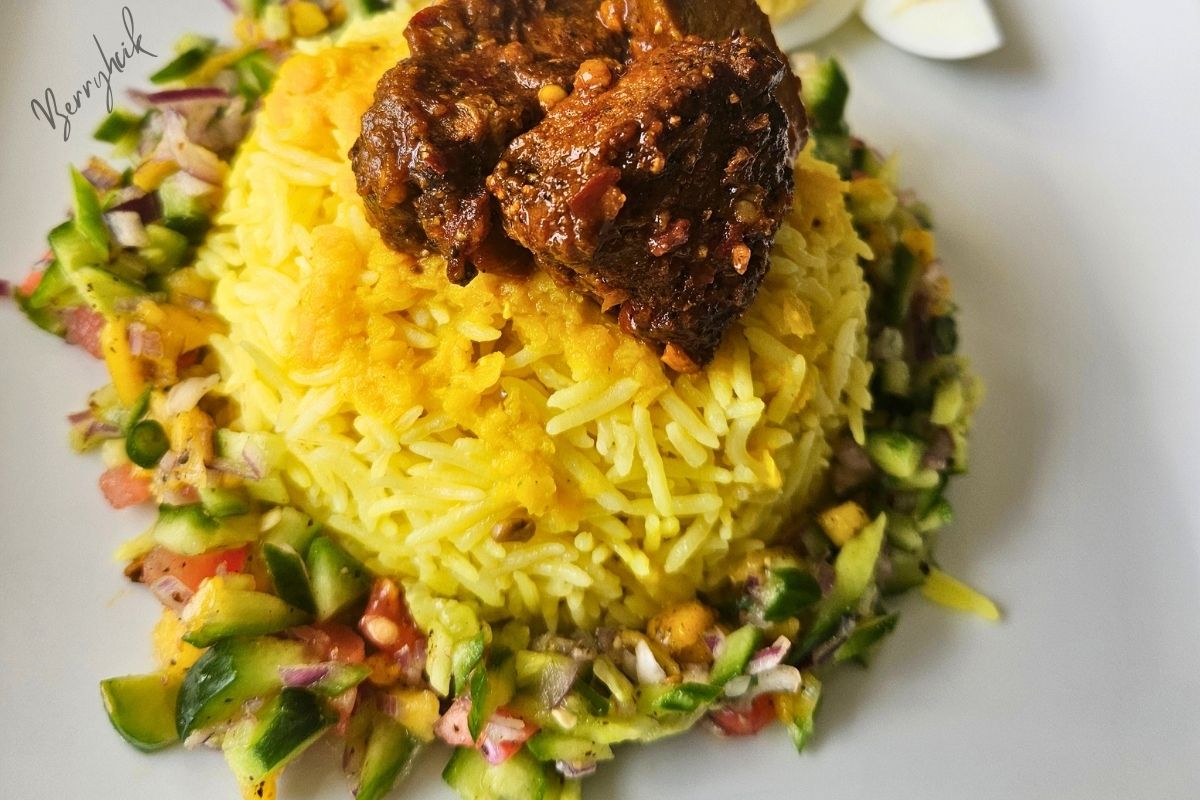 Sri Lankan yellow rice served with devilled-style meat and a fresh cucumber pineapple salad on the side.