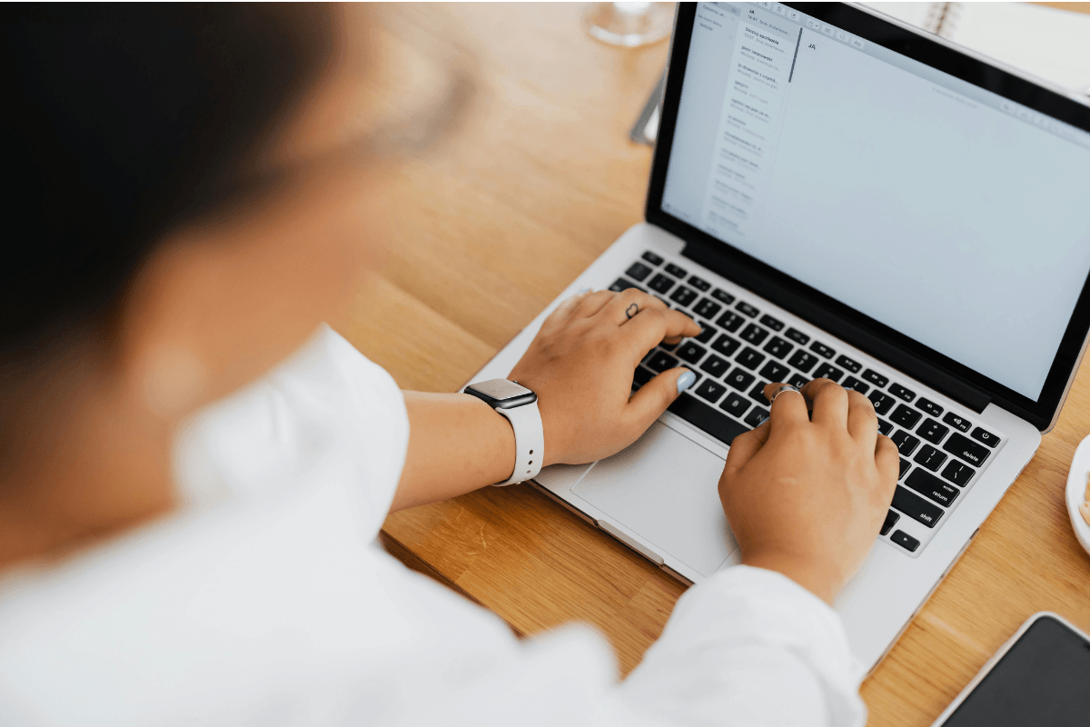 Person working on a laptop at a desk editing a recipe blog post draft