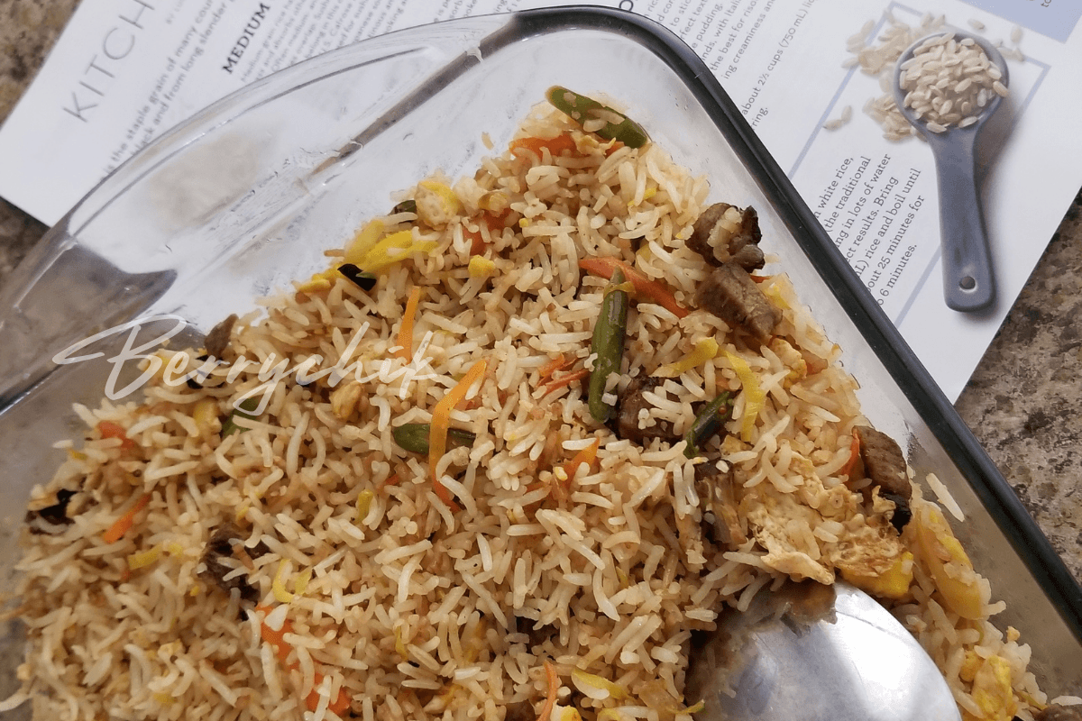 Homemade fried rice with chicken, vegetables, and egg served in a glass baking dish