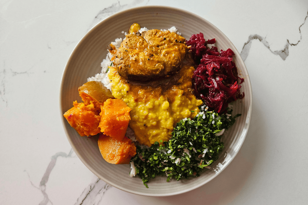 Sri Lankan rice and curry meal with pumpkin curry and vegetable side dishes