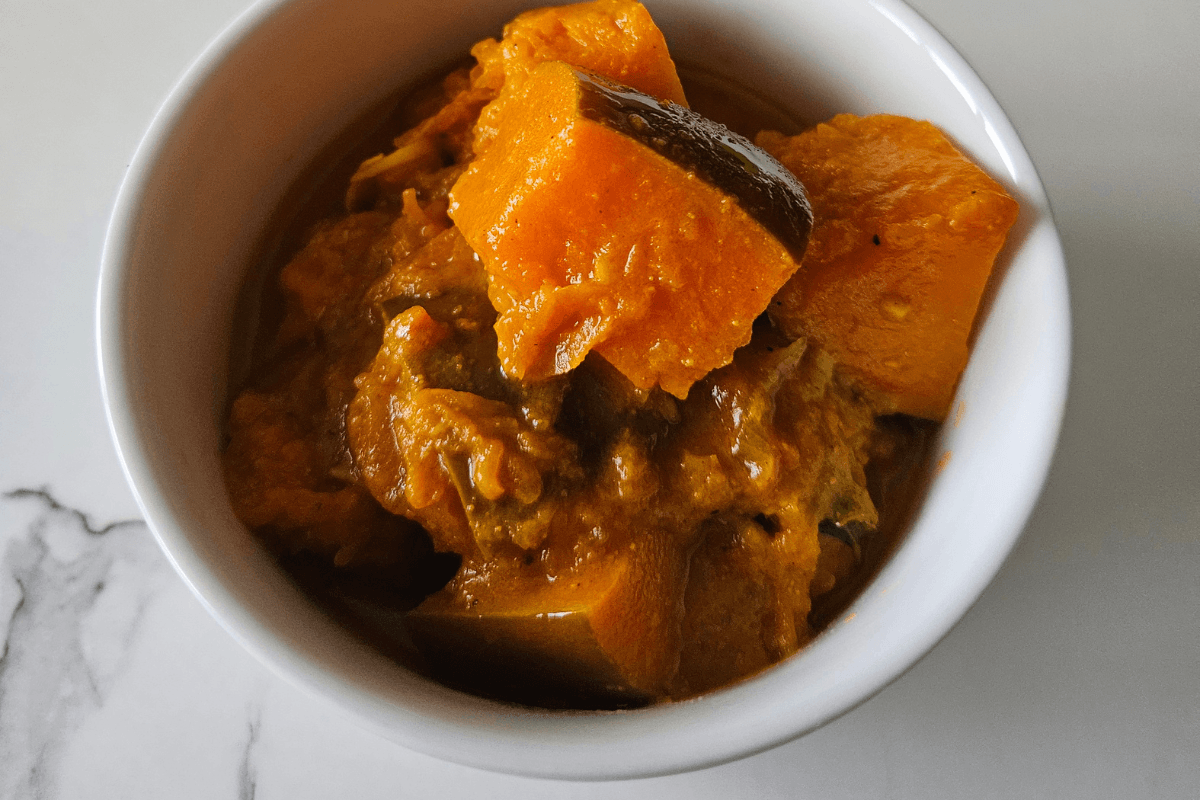 Sri Lankan pumpkin curry served with steamed white rice on a plate